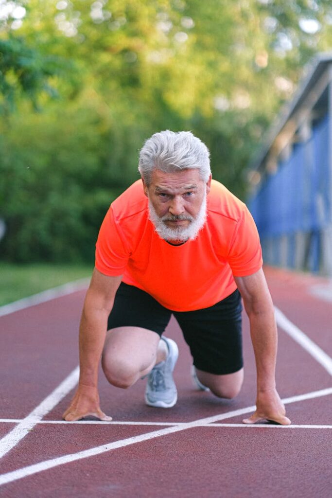 Strong senior sportsman preparing for competition in racing